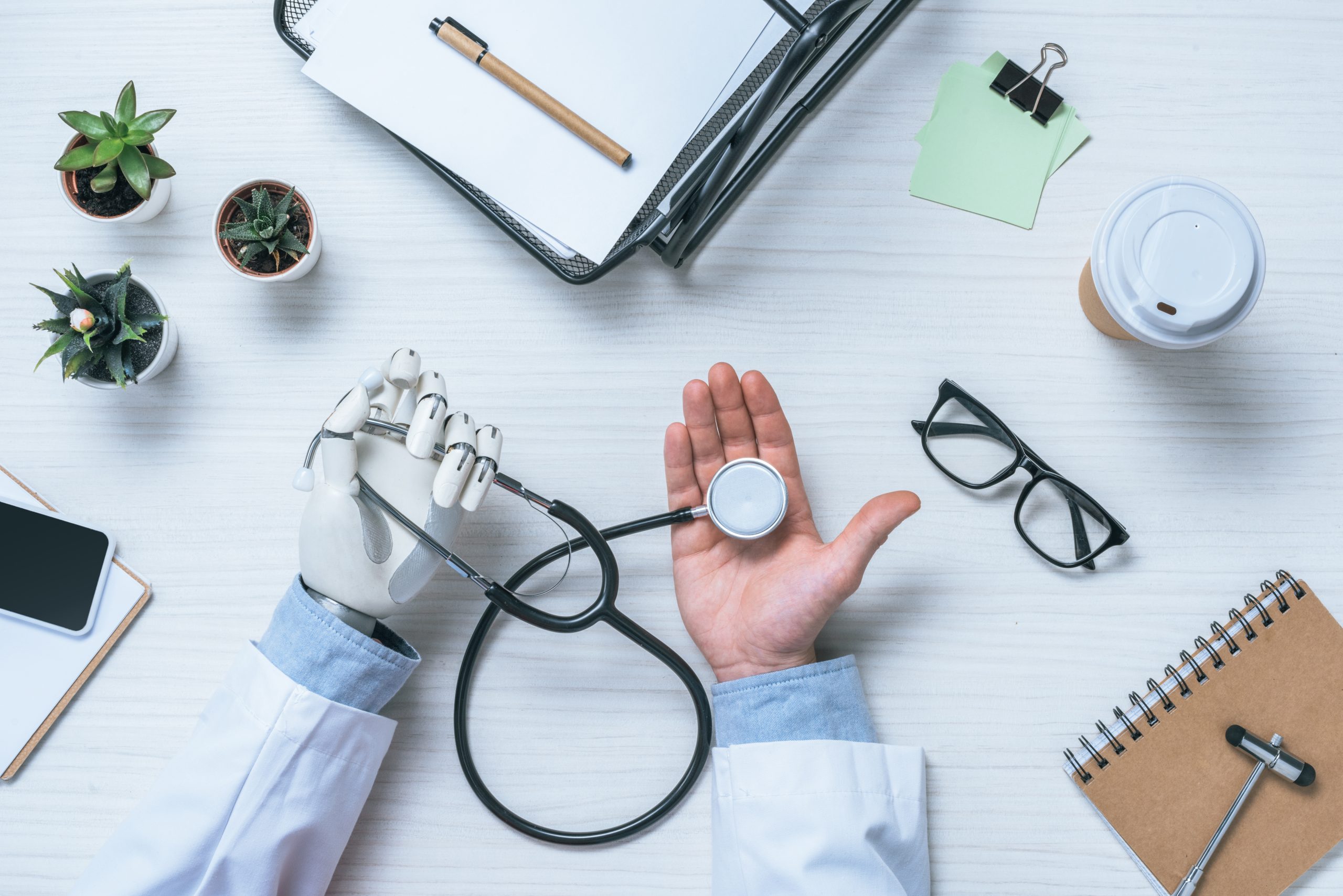 A male doctor with a prosthetic arm holding a stethoscope.