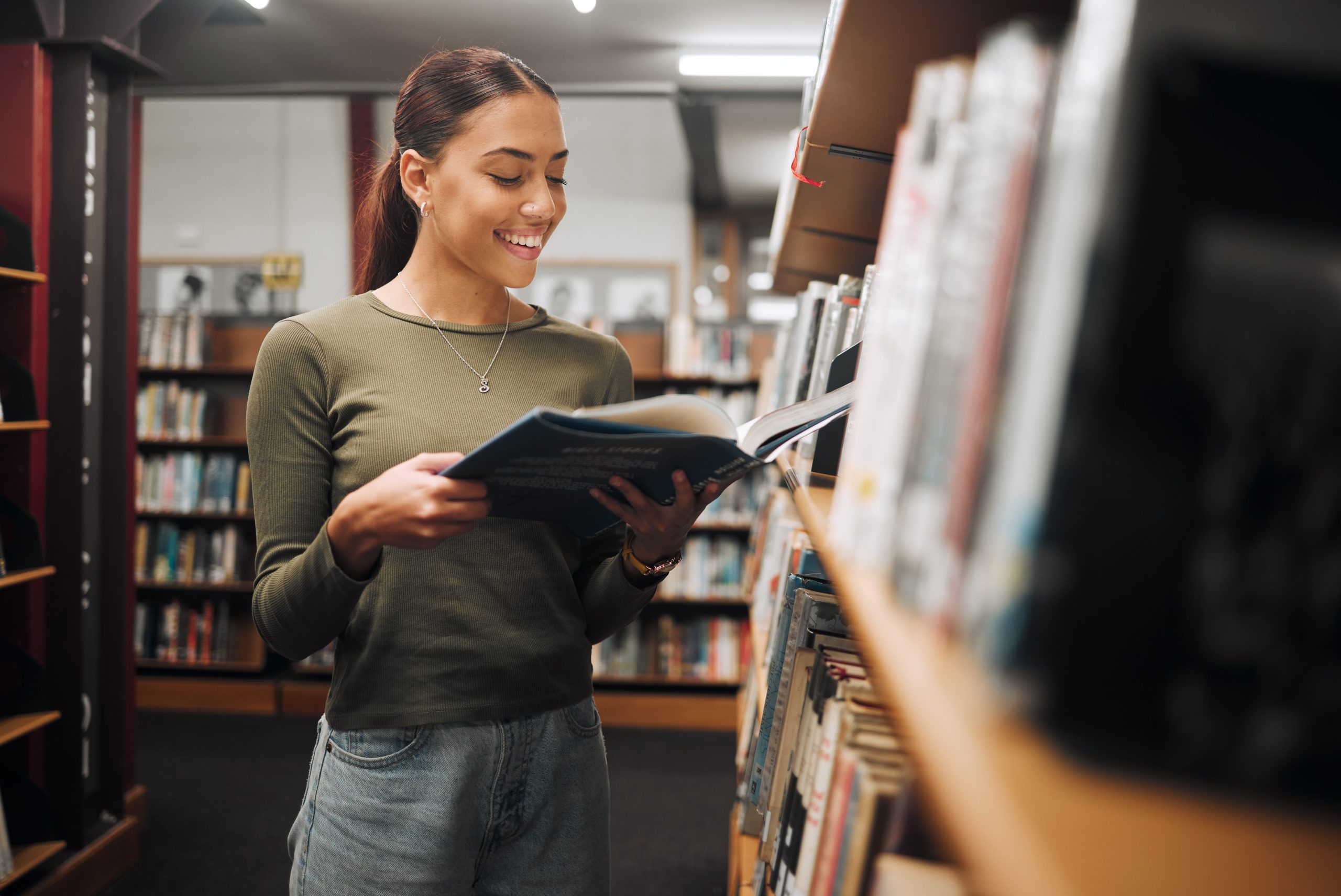 Reading, library book and woman student with a smile about learning, books and college study. Unive.