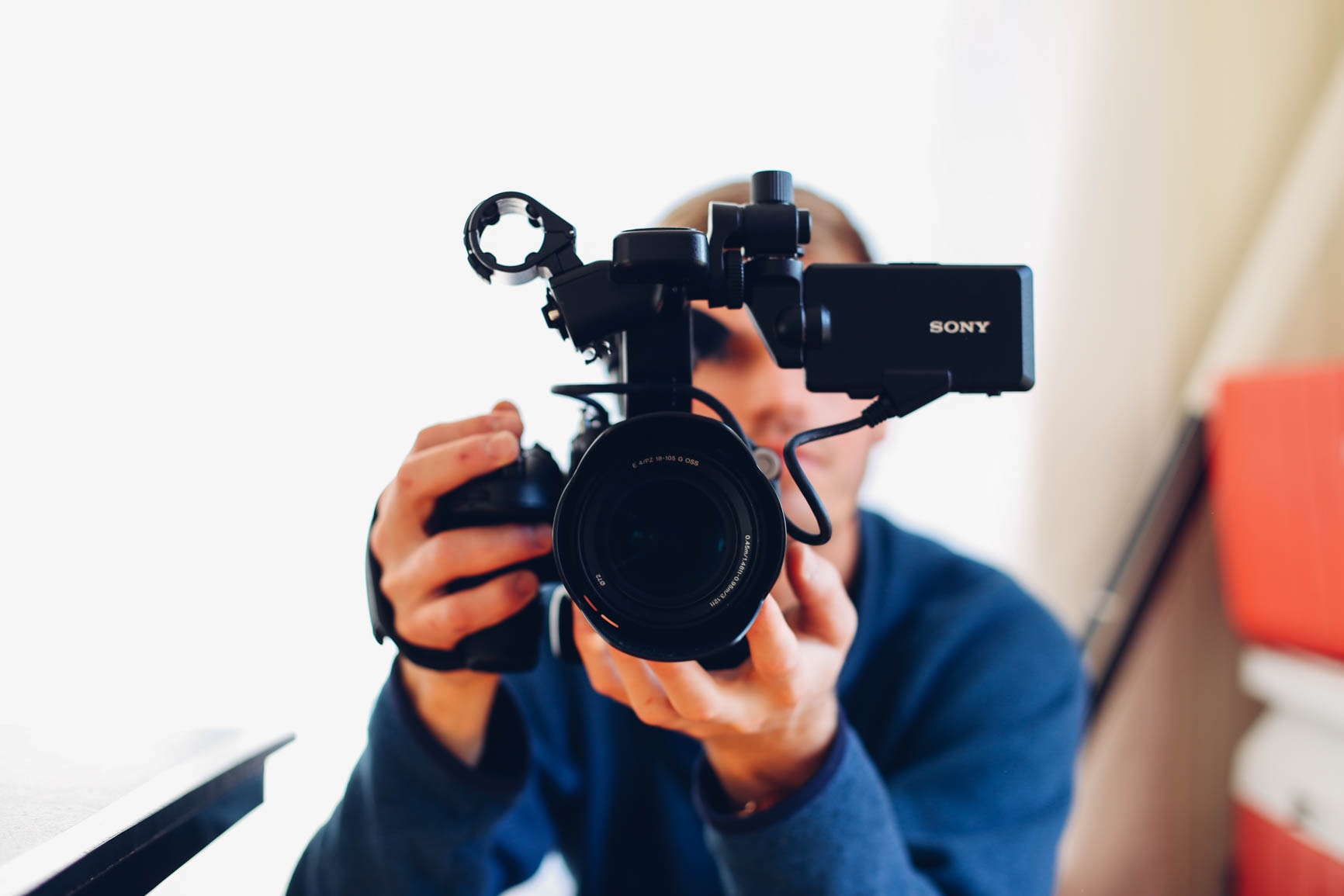 Photo of a man holding up a video camera