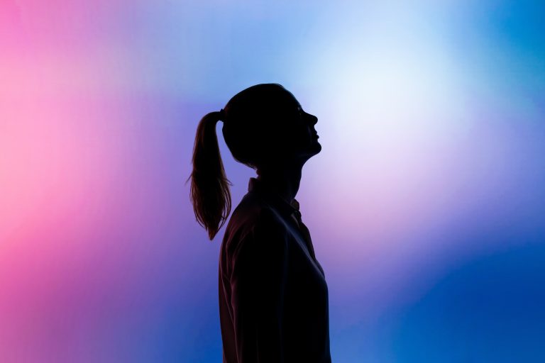 Silhouette of a woman on a purple background